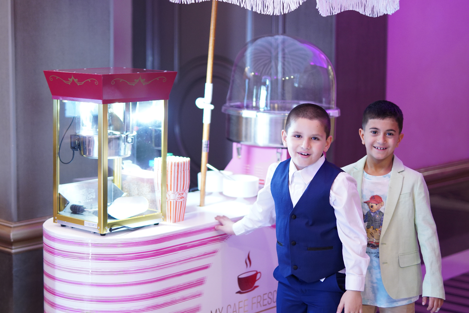 Kids posing at the My Cafe Fresco popcorn and cotton candy cart