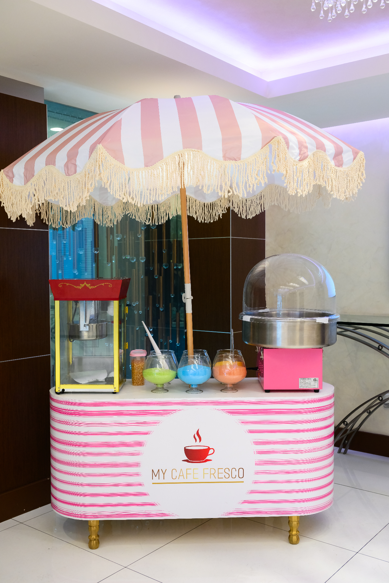 My Cafe Fresco cotton candy cart with striped umbrella and flavor bowls