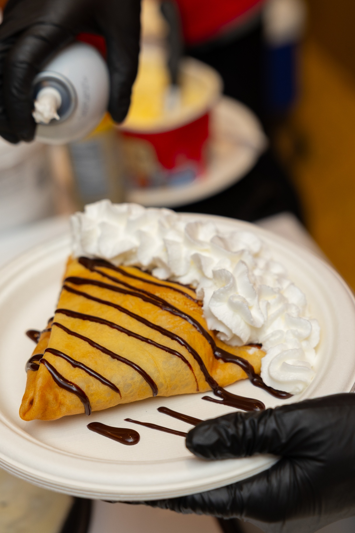 Folded crepe with chocolate sauce and whipped cream