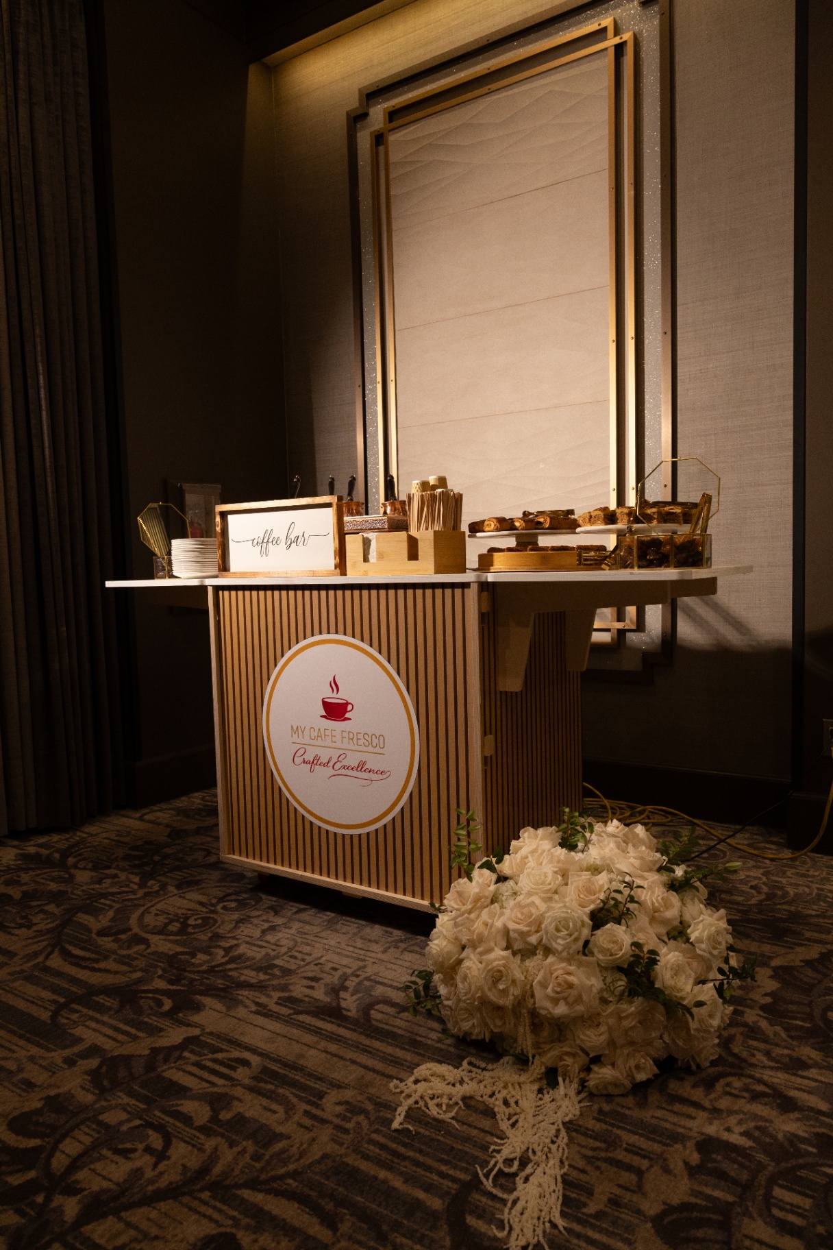My Cafe Fresco Armenian coffee bar setup with sand brewer, pastries, and white rose florals