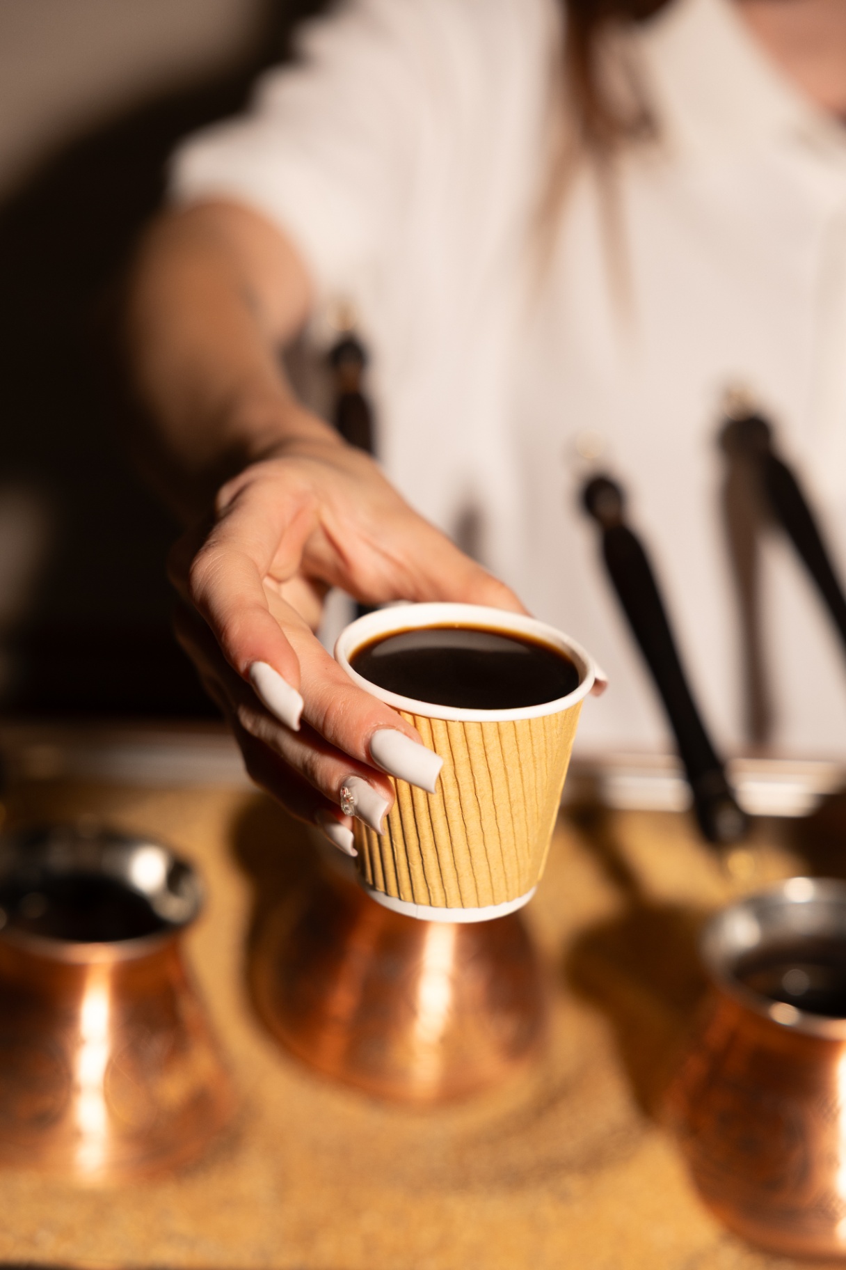 Freshly brewed Armenian coffee served in a ripple cup over the sand brewer