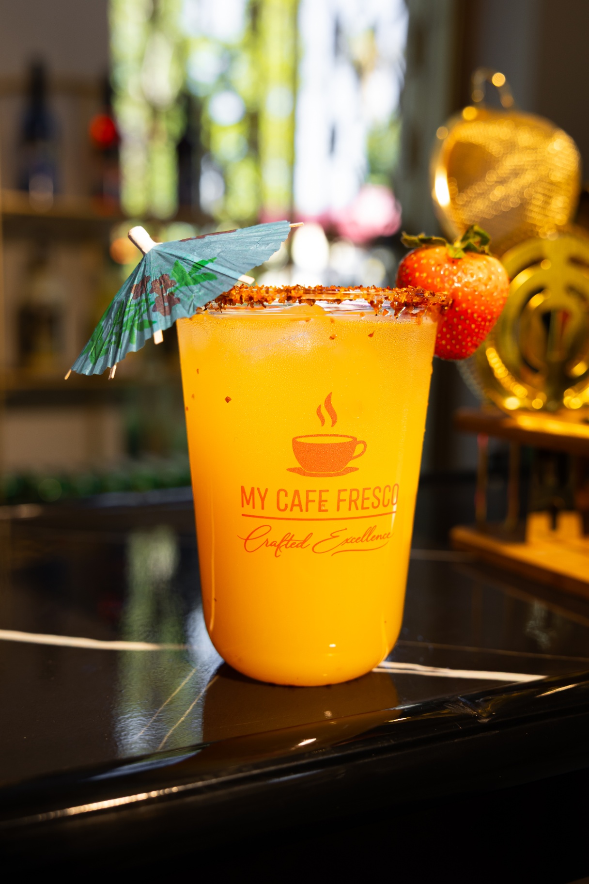 Mango mocktail with tajin rim and fresh strawberry